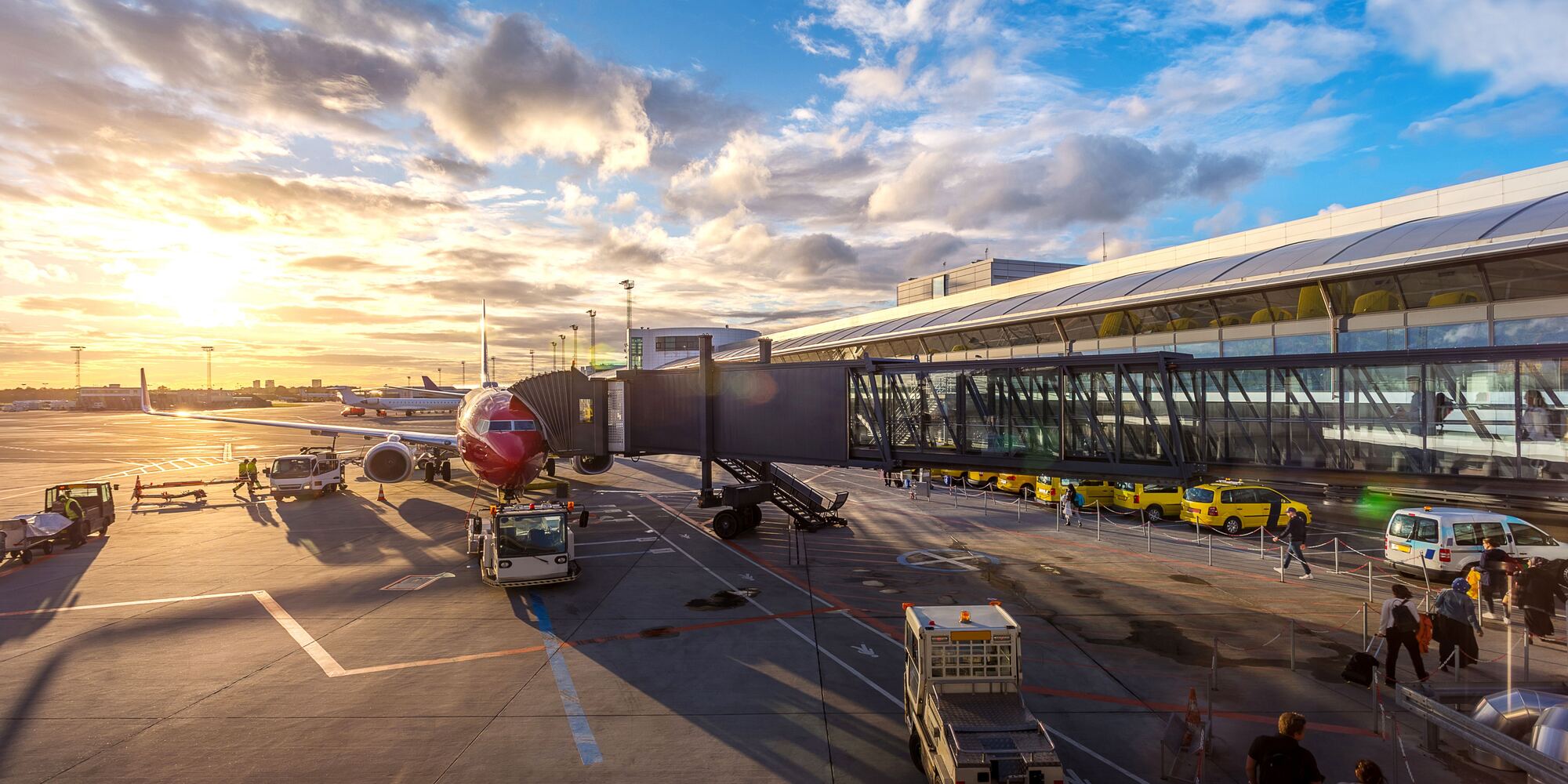 Aircraft at an airport gate at sunrise
